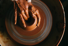 Crop Artisan Making Clay Pot On Wheel 