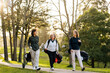 © Sergio Marcos/Stocksy - Golfer women carrying clubs
