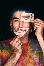 Man With Printed Photo Cutout Paper Eye And Mouth In Studio