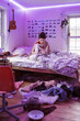 © Léa Jones/Stocksy - college student studying in messy room