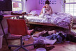 © Léa Jones/Stocksy - college student studying in messy room