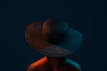 Portrait Of A Young Afro Woman With Hat On Dark Blue Background