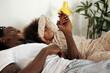 © Malquerida Studio/Stocksy - Close up of a father and his daughter with joined hands in bed