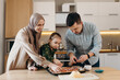 © Stereo Shot/Stocksy - Happy Muslim family making pizza at home