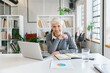 © Mihajlo Ckovric/Stocksy - Portrait of a senior businesswoman working in the office
