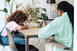 © Malquerida Studio/Stocksy - Man working with laptop at home while his daughter is doing homework
