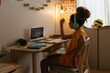 © BONNINSTUDIO/Stocksy - Schoolchild learning online at home in evening
