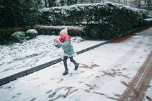 Little Girl Running In The Snow
