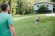 © Maria Manco/Stocksy - father and son play catch outside