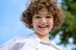© Irina Ozhigova/Stocksy - Portrait of a cute little boy with a curly hair.