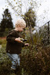 © Melissa Milis Photography/Stocksy - Little toddler boy helping out in the garden