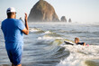 © Jennifer Bogle/Stocksy - Laughing boy boogie boards while his father watches on.