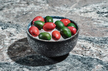 Fresh Olives On A Plate With Ice In A Ceramic Plate On A Stone Background