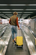 © Alina Hvostikova/Stocksy - Unrecognizable man walking on escalator in airport