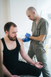 © Vradiy Art/Stocksy - Young doctor conducts treatment with patient in hospital