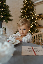 Kid Boy At The Kitchen Table At Home Christmas Holiday New Year Mood 