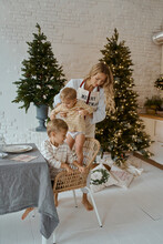 Mother With Children At The Kitchen Table At Home Christmas Holiday New Year Mood 