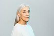 © BONNINSTUDIO/Stocksy - Modern senior female under blue light