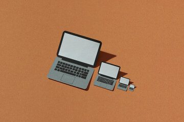 Laptop made by craft paper on brown background