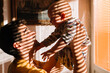 © Alexandra Bergam/Stocksy - Father and baby playing by the window morning light