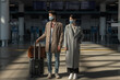 © Milles Studio/Stocksy - Man and woman waiting for flight during pandemic