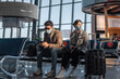 © Milles Studio/Stocksy - Couple in masks waiting for flight together