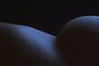 © Sonja Lekovic/Stocksy - minimalistic body part composition in blue light on black background