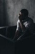 © Oleksii Syrotkin/Stocksy - Upset man inside in dark studio