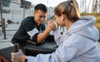 © Milles Studio/Stocksy - Young athletes arm wrestling in park