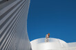 © Milles Studio/Stocksy - Woman resting on roof of modern building