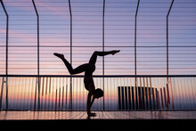 Unrecognizable Female Doing Handstand With Splits At Sunset