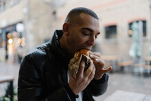 Man Eating A Hambburger Outdoor In Camden Town