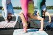© zheng long/Stocksy - Young women practice yoga in the park