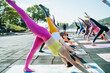 © zheng long/Stocksy - Young women practice yoga in the park