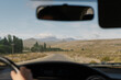 © Felix Chacon/Stocksy - car view of a road with mountains and hills