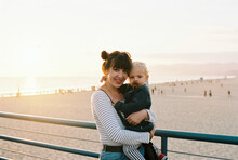Little Boy And His Mother At Santa Monica Beach By Sunset