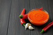 Freshly Sriracha Hot chilli Sauce in bowl on wooden background.