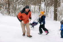 Young Girl Throwing A  Snowball On Her Dad 