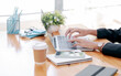 © NAMPIX - Cropped shot of woman hands working on laptop computer while sitting at her office desk.