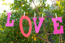 The Letters Spelling Love Hanging From A Clothes Line