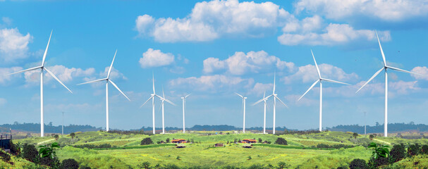 Wind Turbine Alternative on a green meadow and blue sky banner. Renewable clean energy and Eco-friendly sustainable energy concept background.