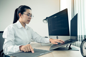 Wall Mural - software developers are analyzing about the code written into the program on the computer in office 