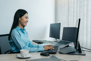 Wall Mural - business woman working on desktop computer monitor professional and sitting at her office desk and w
