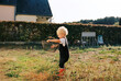 © Melissa Milis Photography/Stocksy - toddler standing in garden full of weed