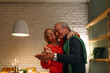 © Studio Firma/Stocksy - A Senior Couple Celebrating Christmas at Home