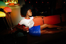 Young Beautiful Black Woman With Afro Drinking Whiskey