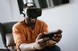 © VICTOR TORRES/Stocksy - Cheerful black man experiencing virtual reality in VR glasses