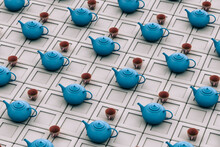 Blue Teapot With Teacups On Grey Background