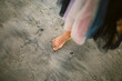 © Erin Brant/Stocksy - Bare foot of girl standing on beach