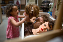 Creepy Image Of Young Girl Holding Hairdresser Mannequin Heads
